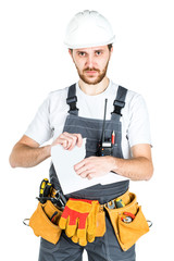A builder or worker in a protective helmet breaks the contract that he holds in front of him. Isolated on white background