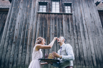 The newlyweds cut the wedding cake.