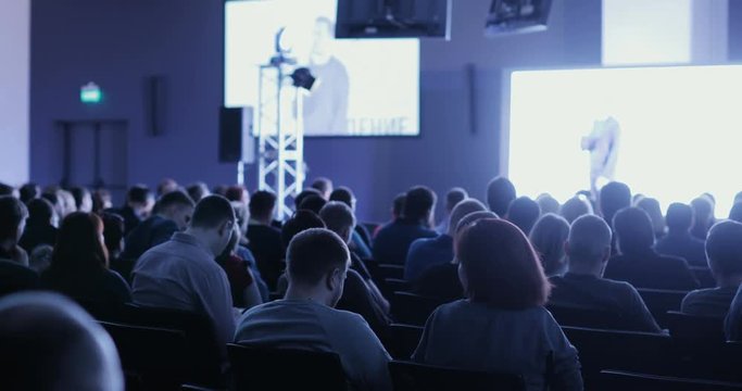 people at a conference or presentation, workshop, master class photograph. Back view