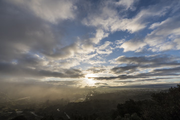 Naklejka na ściany i meble Los Angeles San Fernando Valley misty morning sunrise with clearing storm clouds at Santa Susana Pass State Historic Park. 