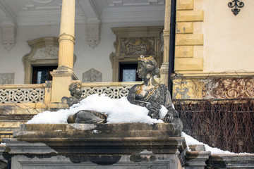 Sculptural composition of the 19th century and part of the architecture of Sinai, Romania. In the winter.