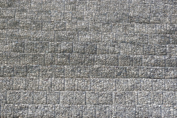 Natural stones laid in the wall and reinforced with steel wire mesh.