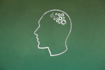 Human head Concept Drawing on Blackboard Texture