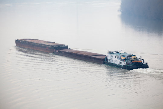 Tugboat Pushing A Heavy Barge