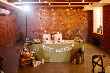 Wedding. Banquet. Table for a honeymoon with wooden signs 