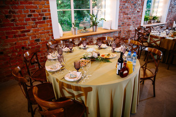 Festive table, served with dishes and decorated with sweet gifts