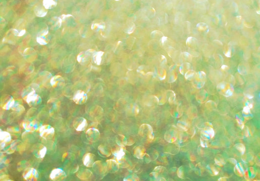 glowing glitter blurred background with colored holographic sparkling effect