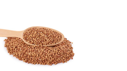 healthy buckwheat grains in wooden spoon isolated on white background. copy space, template