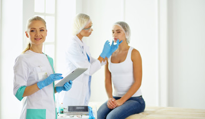 Obraz premium Permanent Makeup For Eyebrows. Beautiful Woman With Thick Brows In Beauty Salon. Beautician Doing Eyebrow Tattooing For Female Face. Beauty Procedure