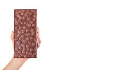 chocolate bar with nuts in hand isolated on white background. copy space, template