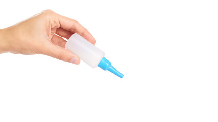 White glue container in hand isolated on a white background. copy space, template