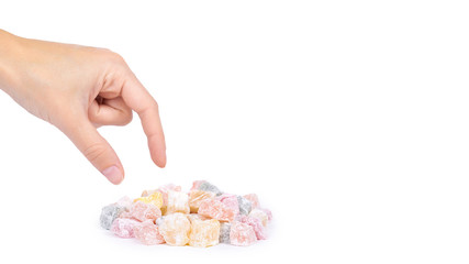 Turkish delight sweets in hand isolated on the white background, colored candy, natural product. copy space, template