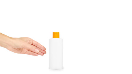 Plastic white shampoo bottle with orange cap in hand isolated on white background. Gel dispenser for hair care. Container with body lotion. copy space, template.
