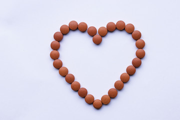 vitamins medication in hart shape red pills