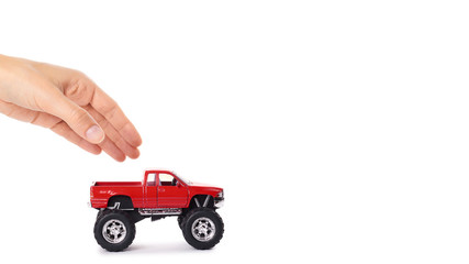 big metal red toy car offroad with monster wheels in hand isolated on white background. copy space, template © Sviatoslav Kovtun