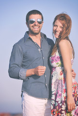 happy young couple have romantic time on beach