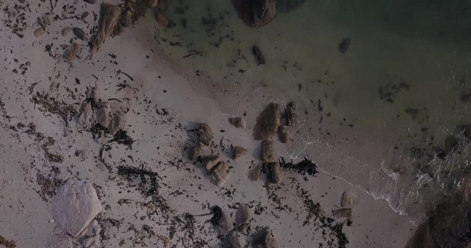 4K high quality aerial video footage of Western Cape's coast, Paternoster beach boulders, sandy sea front and Atlantic Ocean views in the background near Cape Town, South Africa on summer morning