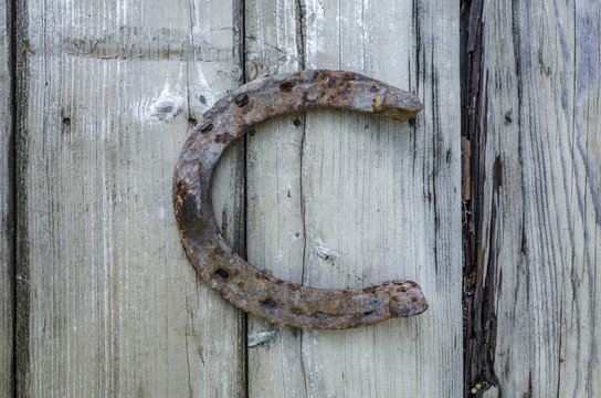 An old horseshoe on a wooden table