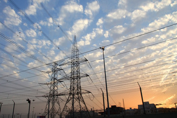 Electricity pylons and power lines, at sunset