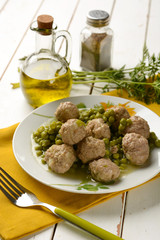 meatballs with peas garnish in white plate