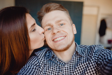 Couple man and woman making selfie photo with kiss
