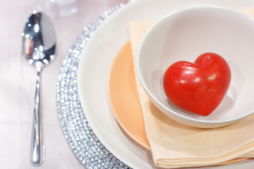 Inside interior table setting with beautiful plate of hearts