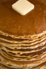 A Background of a Stack of Fresh Buttermilk Pancakes with Butter and Syrup