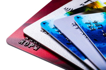 Close Up Credit card payment isolated on white background. Macro shot of chip and pin debit card. Credit and finance concept. Stack of credit cards. Debit cards. Shallow depth of field