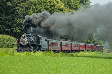Fototapeta na wymiar Antique Steam Engine Train with Vintage Passenger Cars