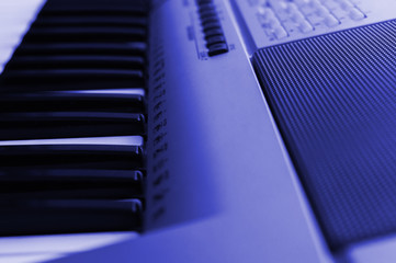 Piano keys and speaker toned,close-up. Side view.