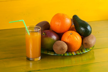 Tropical fruit on yellow wooden background, fresh food