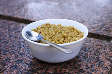 bowl with cooked grain and spoon