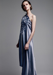 Fototapeta premium Beautiful fashion model wearing blue silk dress