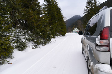 Fototapeta premium Large SUV on a snow serpentine in the mountains