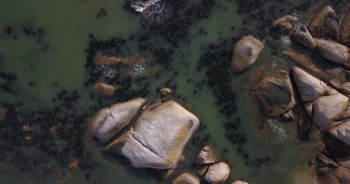 4K high quality aerial video footage of Western Cape's coast, Paternoster beach boulders, sandy sea front and Atlantic Ocean views in the background near Cape Town, South Africa on summer morning