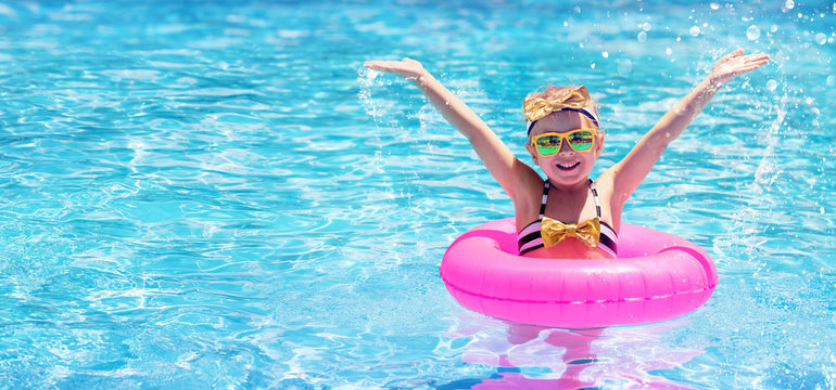 Happy Child Swimming In The Pool
