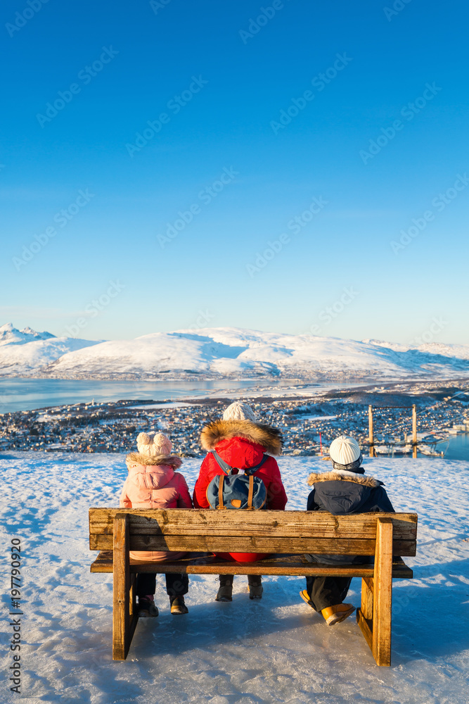 Poster mother and kids outdoors on winter