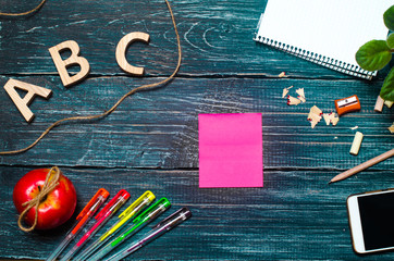 A student's desk on a school board, a dark wooden background made of boards. Concept of education...