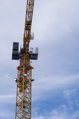 Fototapeta na wymiar large crane against a blue sky in vertical format 