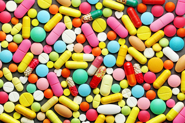 Colorful pills on grey background