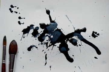 Fototapeta premium A sheet of white paper with black artistic blots made by ink.