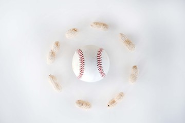 Baseball surrounded by circle of ballpark peanuts on simple isolated white background.
