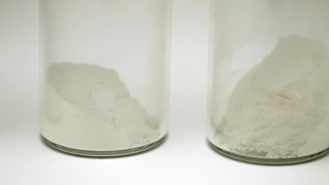 white powder medication inside a glass ampoule. close-up