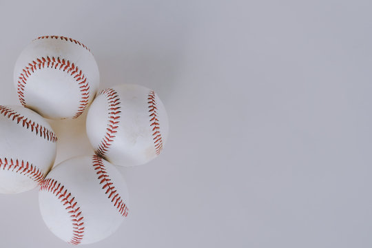 Baseball sport equipment shown with balls on isolated white background.  