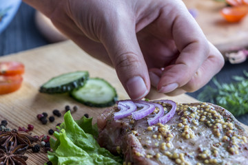 The process of cooking a steak, with all the ingredients on the table, selective focus