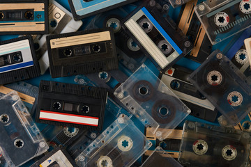 Set of old retro audio cassettes tape on blue background, close-up top view. 