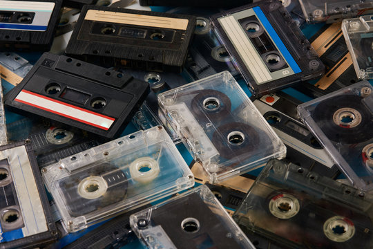 Fototapeta Set of old retro audio cassettes tape on blue background, close-up top view. 