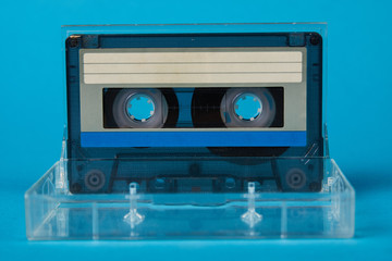 Blank cassette tape box on blue background. Vintage cassette tape case with retro cassette mockup. Plastic analog magnetic clear packaging template. Mixtape box open 