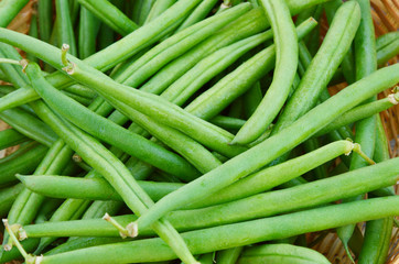 Green beans in the basket  on wooden background