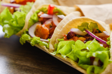 Mexican burrito with chicken, pepper and beans close up